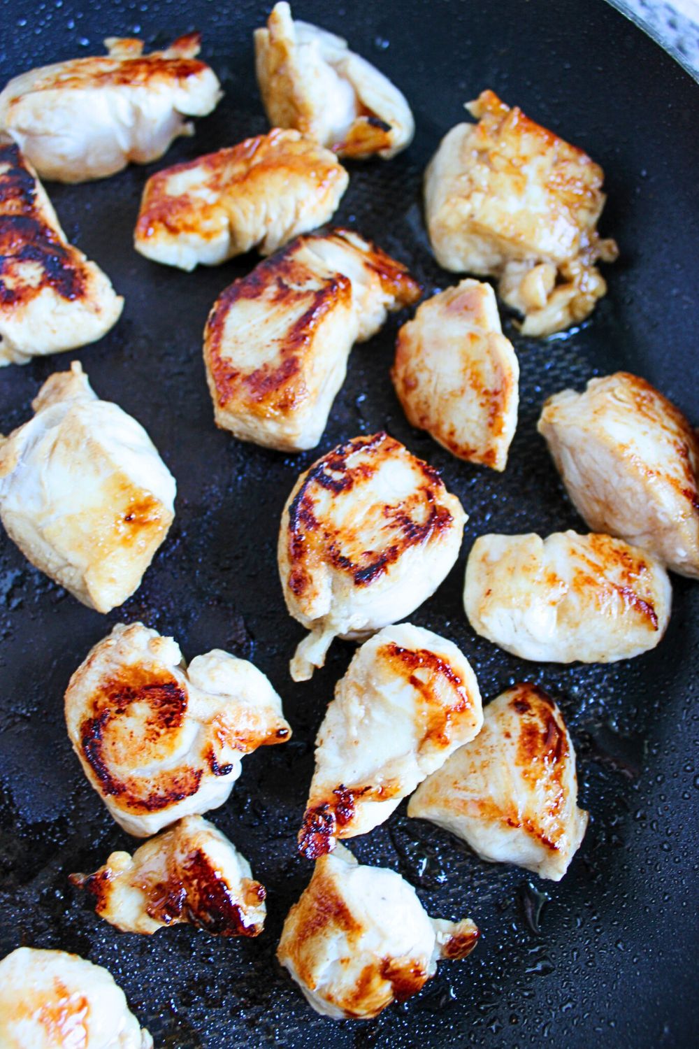 Cubed chicken in a pan.