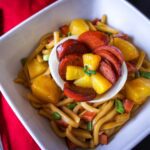 Udon Noodles in a white bowl with chopsticks