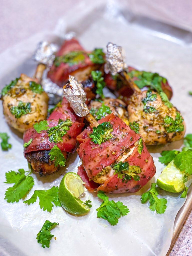 baked cilantro lime chicken with bacon on baking sheet.