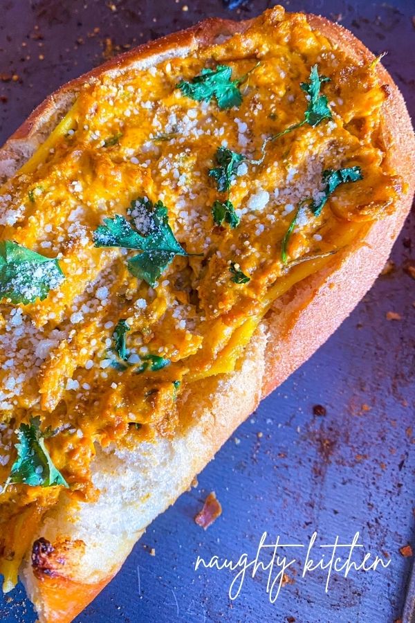 Creamy Chorizo Stuffed French Bread on a Baking Sheet