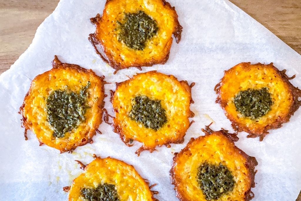 pesto cheese crisps on parchement paper