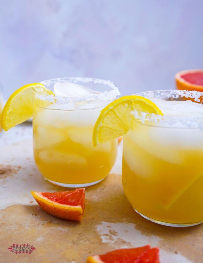 Tequila Punch with lemon wedges