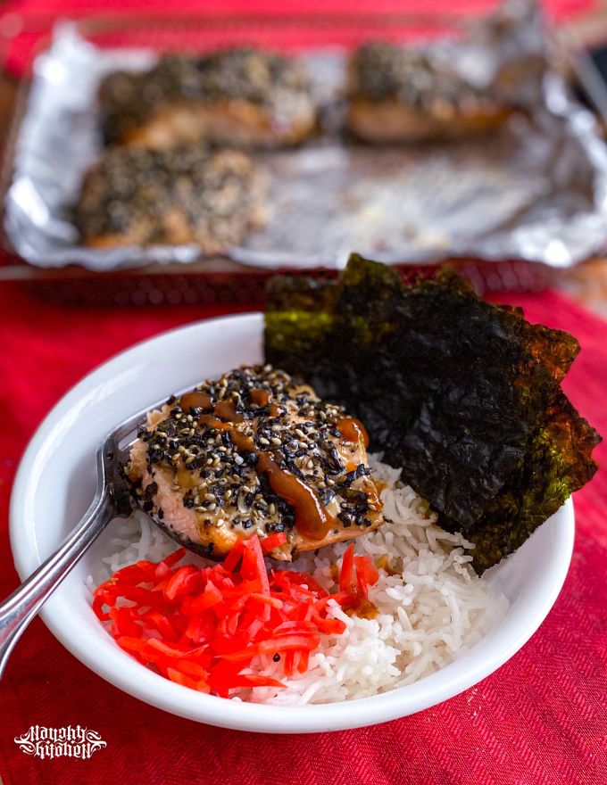 baked furikake salmon in a bowl of rice with red ginger.