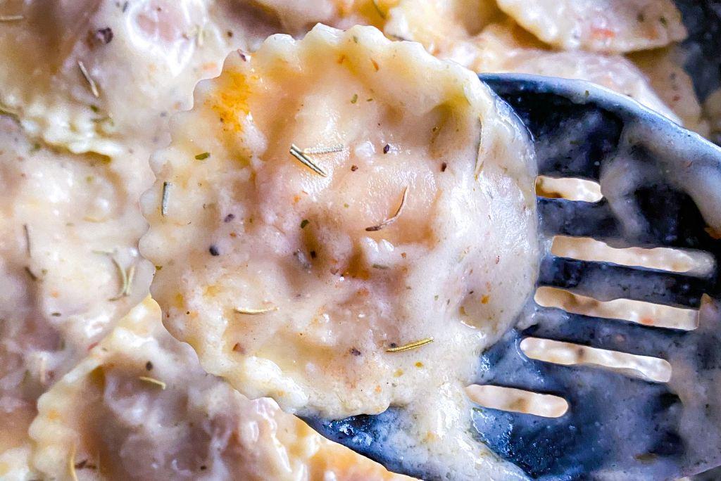 plant based ravioli in herb infused white sauce close up