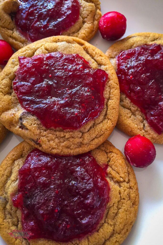 Cranberry jam chocolate chip cookies close up with cranberries.