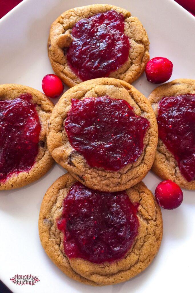 Cranberry jam chocolate chip cookies on a white plate.