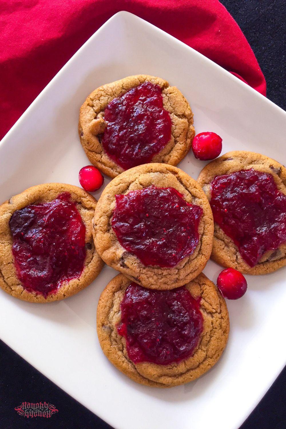 Cranberry jam chocolate chip cookies on a white plate overview.