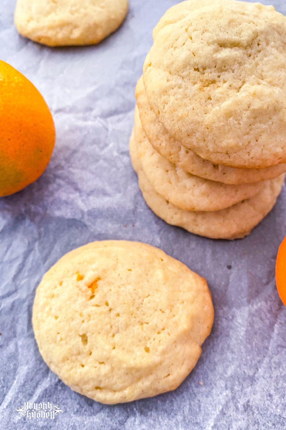 Stacked calamansi cookies on parchment paper.