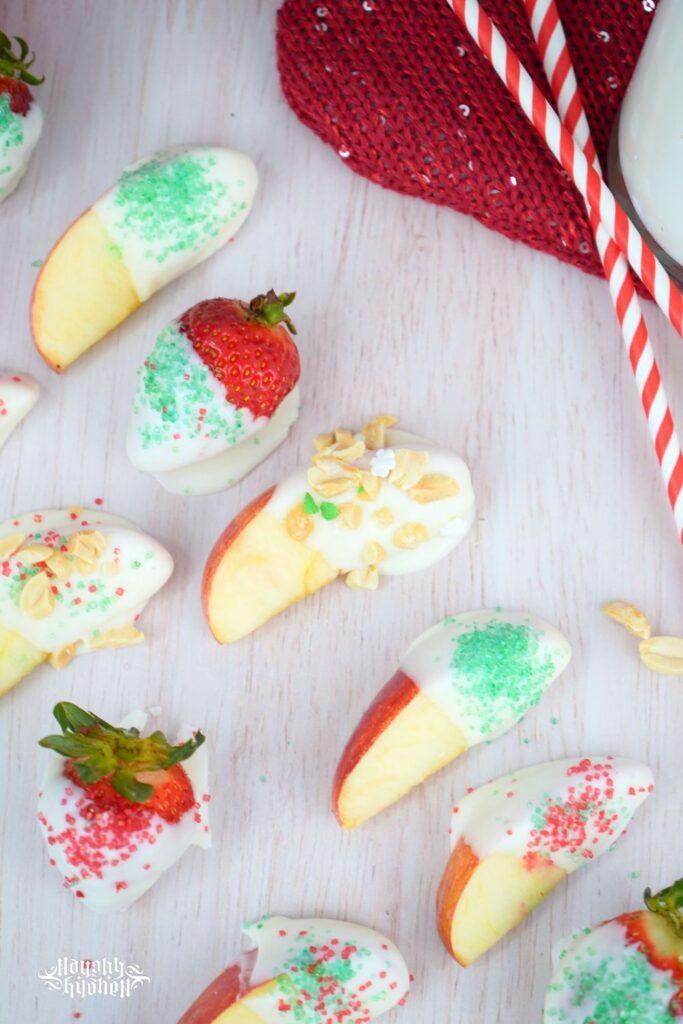 Holiday Dipped Apples and Strawberries with nuts and sprinkles.