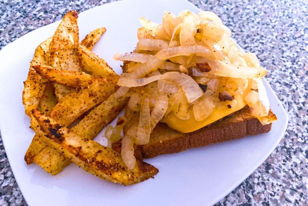 Vegan Patty Melt open faced with potato wedges.