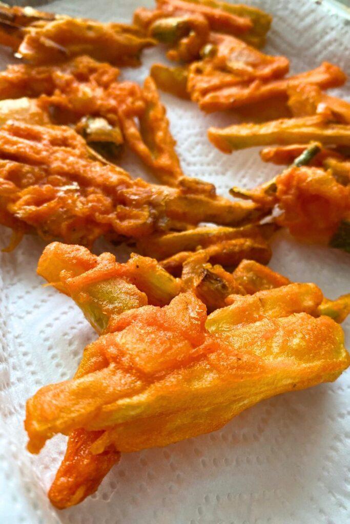 Chayote Squash Fritters on paper towels.