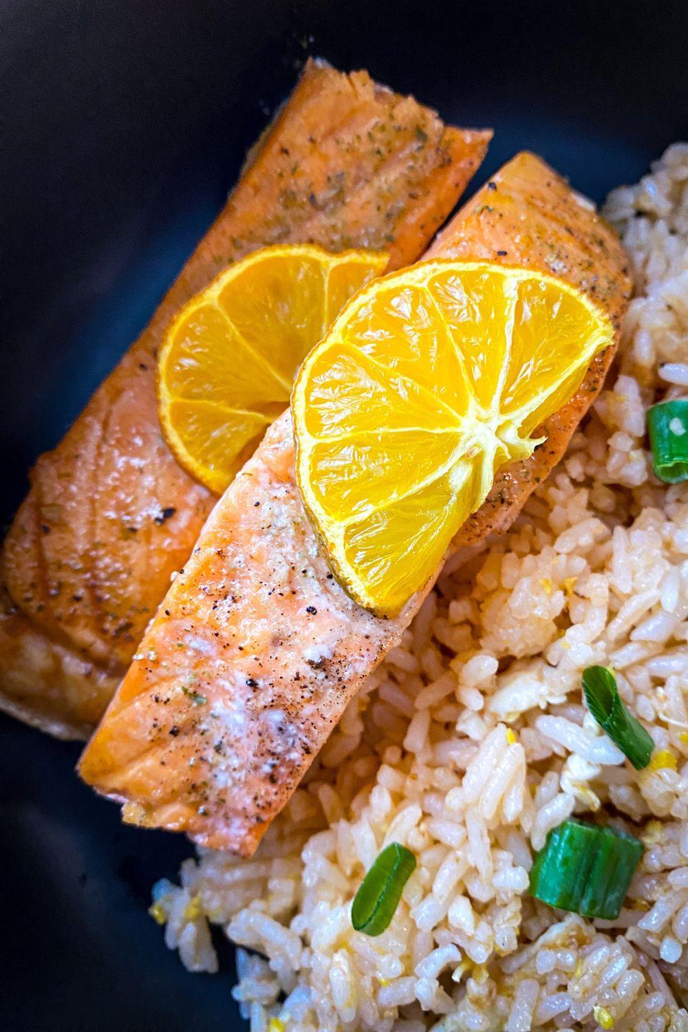 Calamansi Salmon with calamansi slices over fried rice.