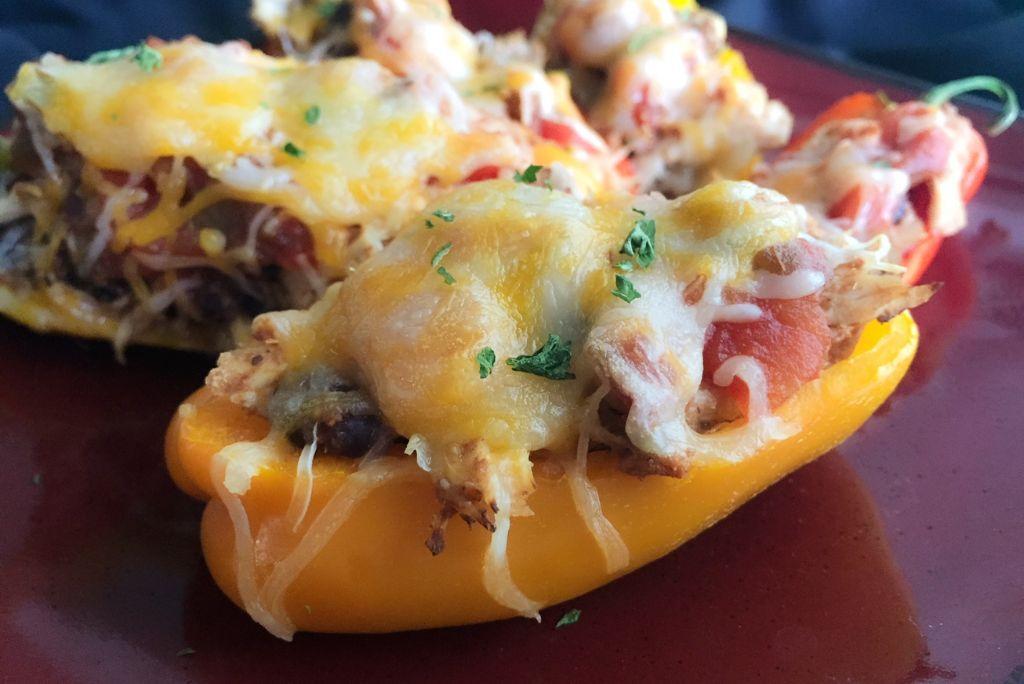 Salsa Chicken Mini Peppers wit melted cheese on a plate.