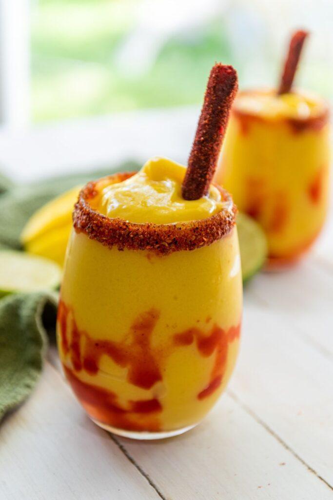 Mangonada with tamarind candy near window.