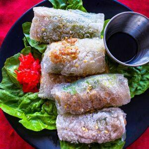 Crispy Rice Paper Dumplings on a black plate.