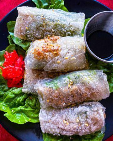 Crispy Rice Paper Dumplings on a black plate.