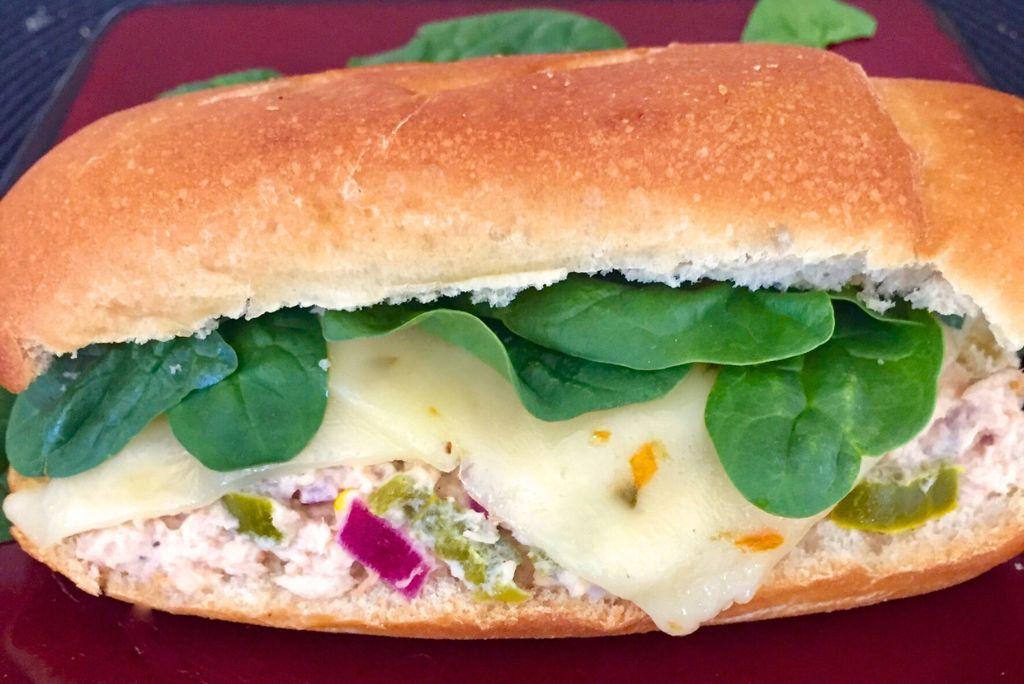 Jalapeno Tuna Melt with spinach in a brat bun.