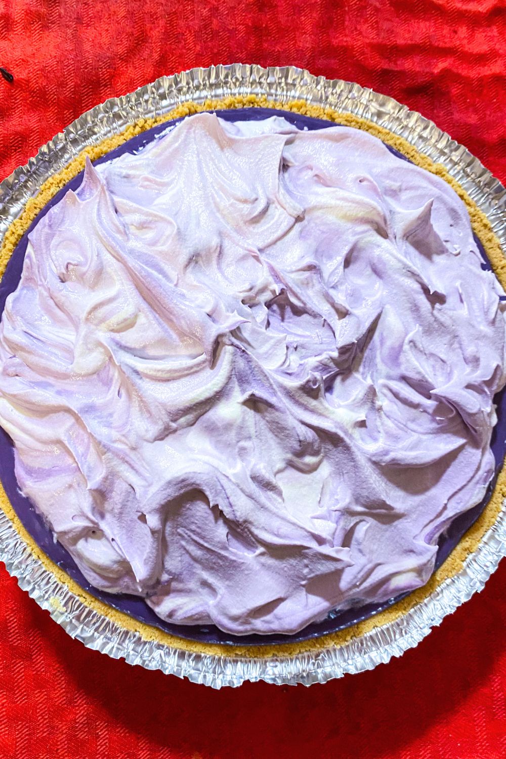 Ube lush pudding pie with whipped cream.