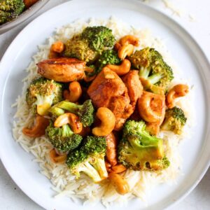 Cashiew Chicken with white rice in a white plate.