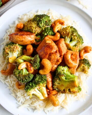 Cashiew Chicken with white rice in a white plate.