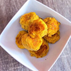 Mac and cheese bites in a white bowl.