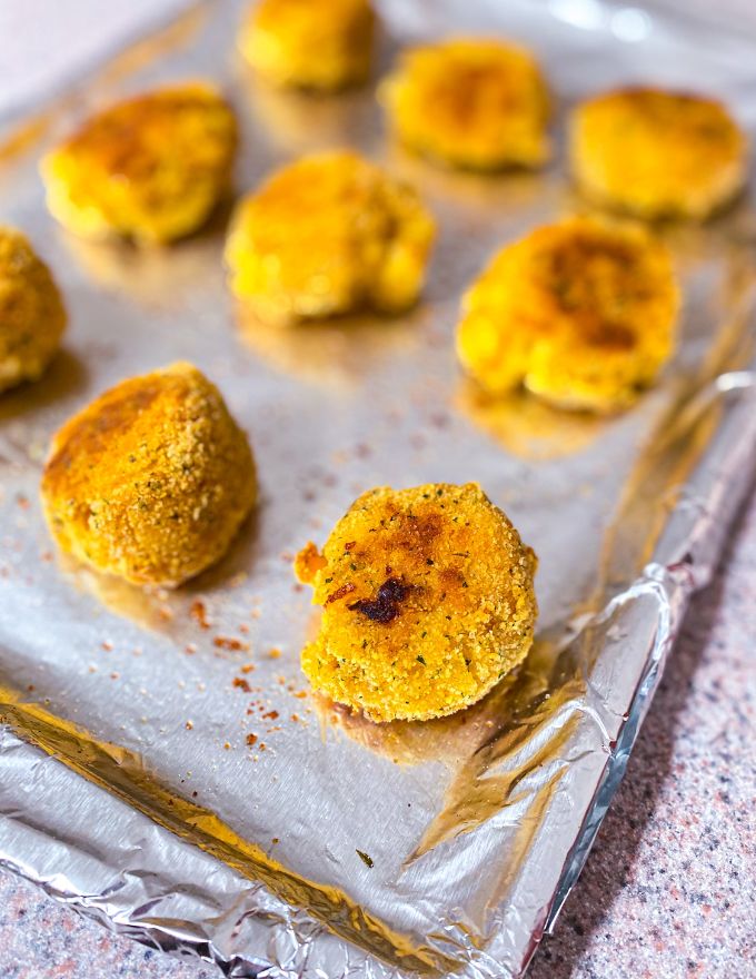 Baked Mac and cheese bites on a baking sheet.