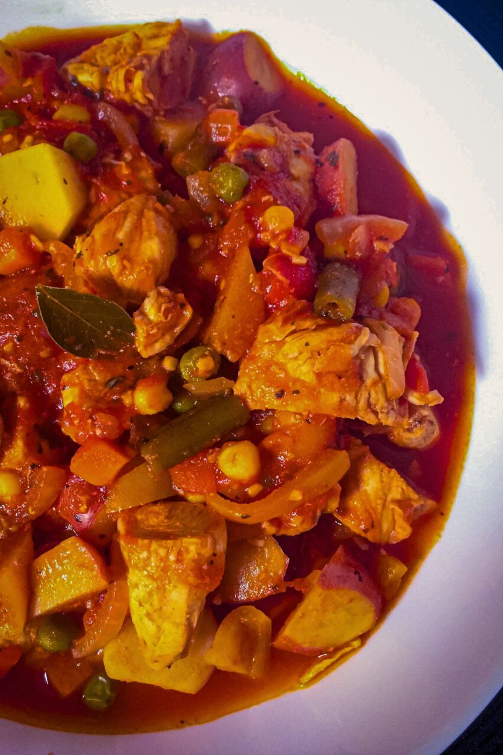 Chicken Afritada in a white bowl.