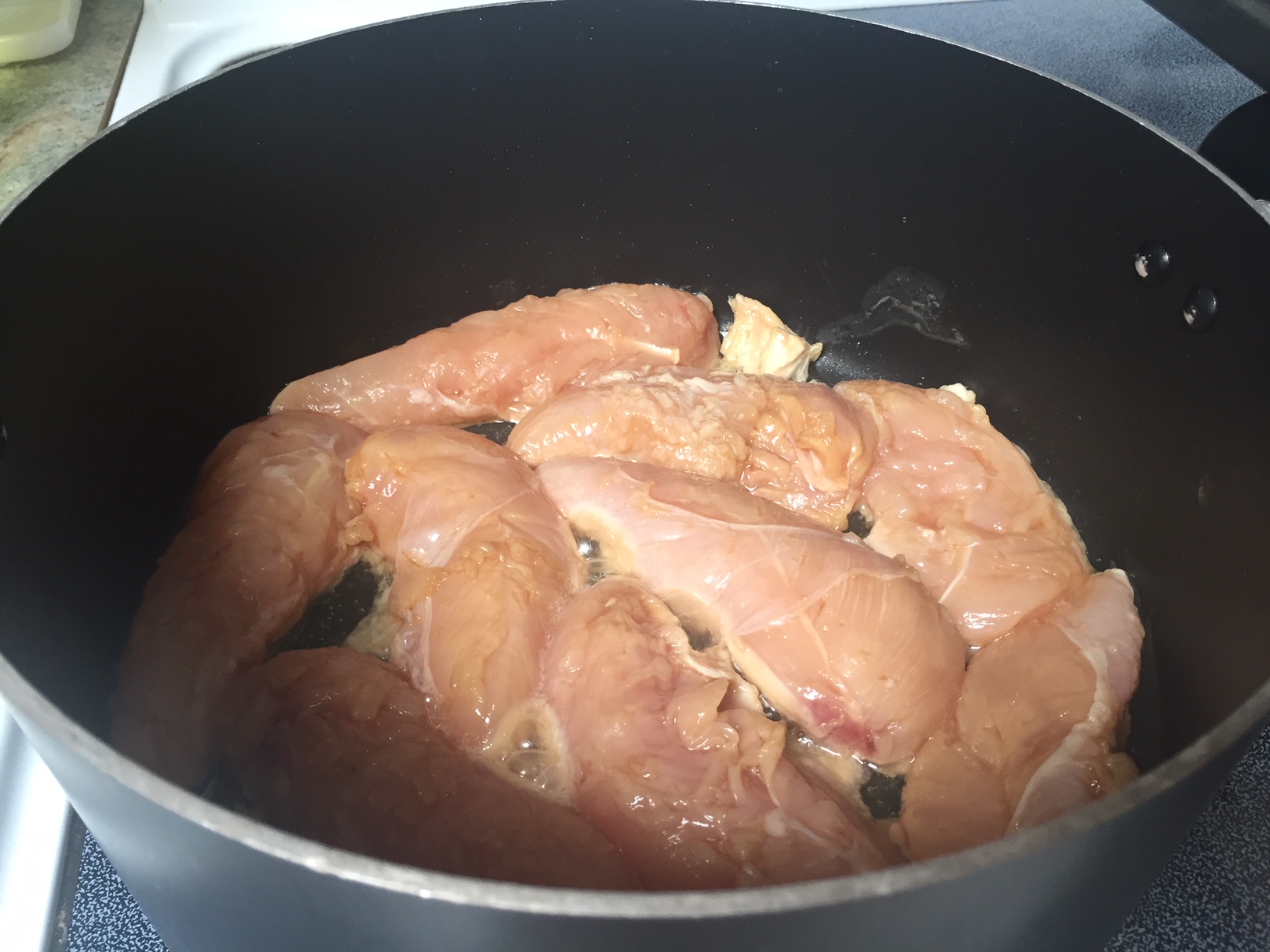 Raw chicken in a pot.