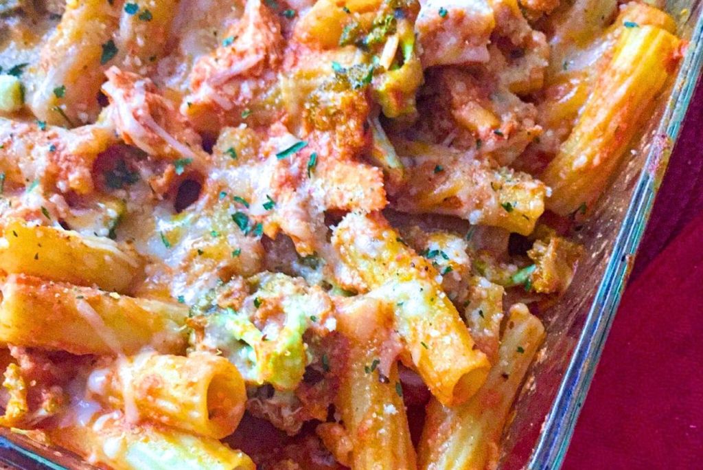 Easy chicken rigatoni casserole topped with shredded cheese and parsley